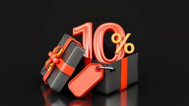 A black gift box with a red ribbon, a red tag, and a large 